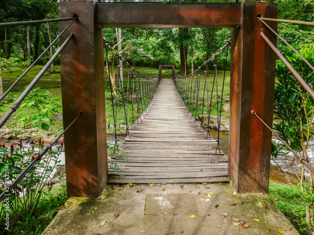 Small wooden suspension bridge for crossing the stream.