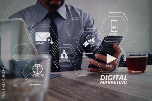 success businessman hand using smart phone,digital tablet docking smart keyboard,on wooden desk