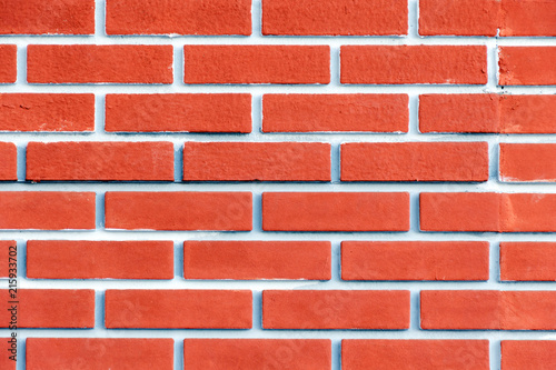 Brick wall of terracotta with pink tint. Bright background.