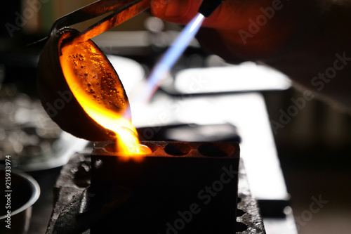 Close up of a goldsmith while he is working to make a diamond ring. Concept: jewelry, silver, gold