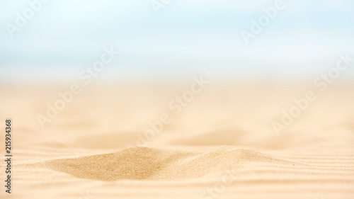 Close up sand beach with blurred sea sky background  summer day  copy space.