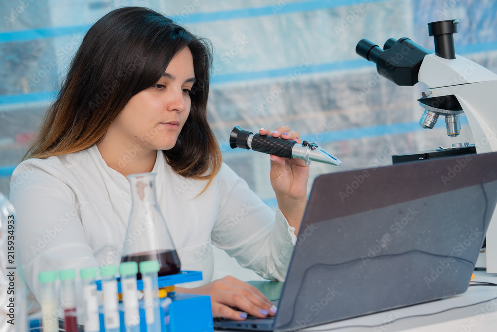 Young female technician in the quality control laboratory of wine quality inspection Young female technician in the quality control laboratory of wine quality inspection