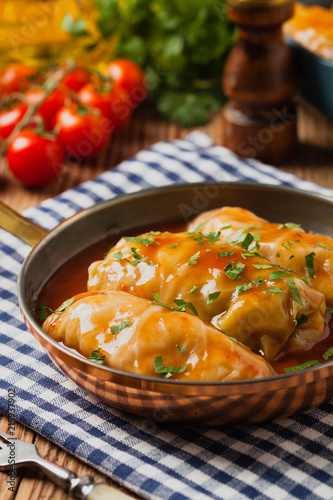 Traditional stuffed cabbage with minced meat and rice, served in a tomato sauce.