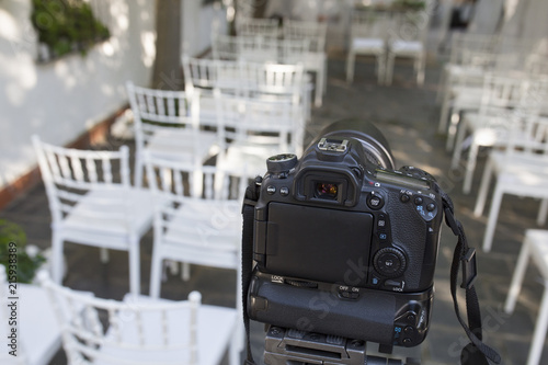 DSLR camera mounted over tripod ready for record wedding photo