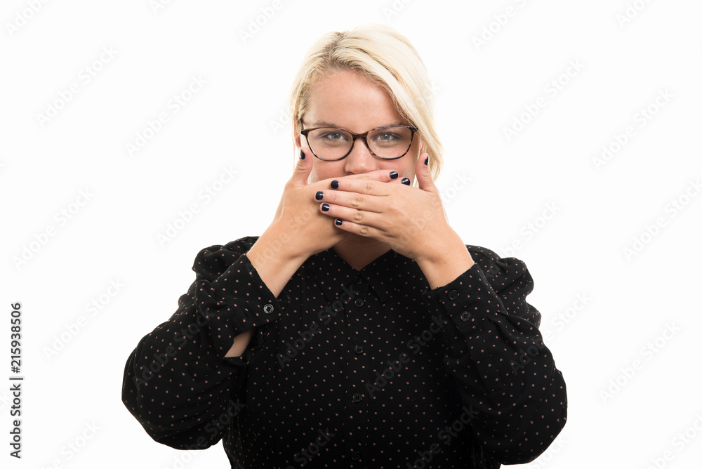 Blonde female teacher wearing glasses covering mouth like mute gesture