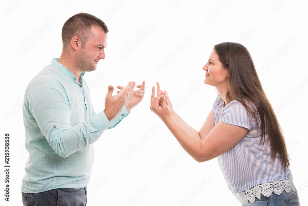 Side view of young couple showing each other middle finger Side view of young couple showing each other middle finger