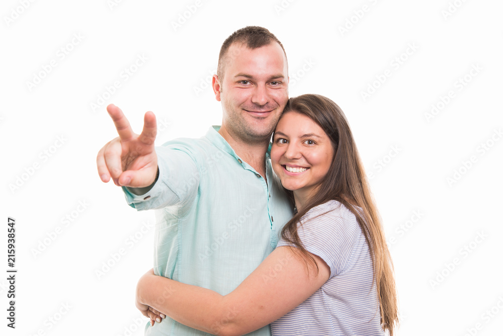 Portrait of young happy couple showing victory gesture Portrait of young happy couple showing victory gesture