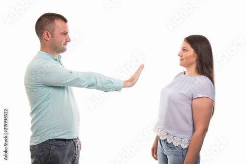 Portrait of young happy couple showing stop gesture