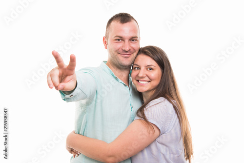 Portrait of young happy couple showing victory gesture