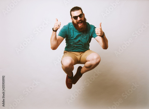 Man jumping and showing thumbs up