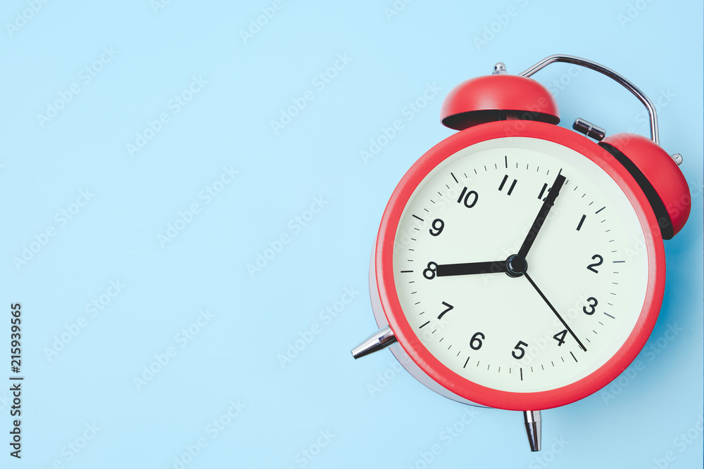 Red vintage alarm Clock show 8 O'Clock copy space on light blue background Stock Photo | Adobe Stock