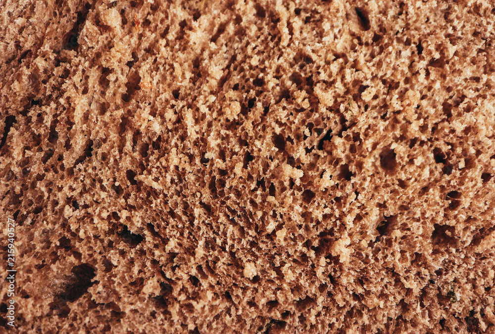 A piece of handmade freshly baked rye bread, texture background, closeup. A piece of handmade freshly baked rye bread, texture background, closeup.