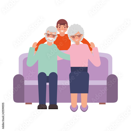 grandparents with grandson sitting on sofa