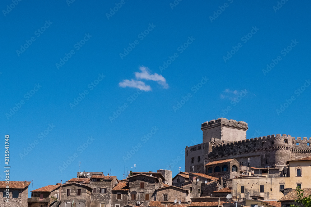 Landscape view of a medieval village with a castle with blue sky background.