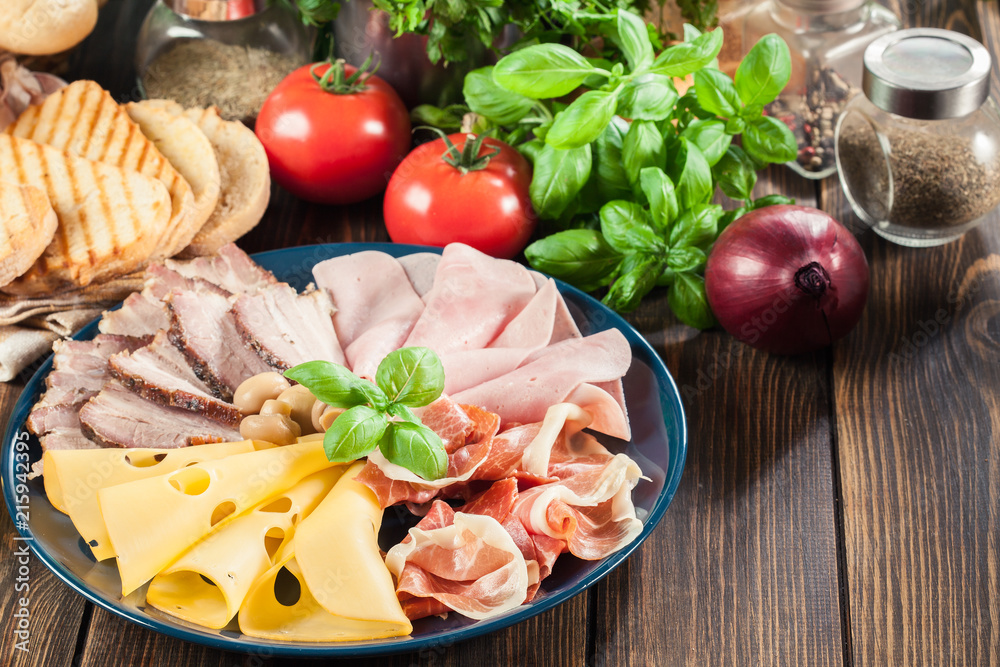 Cold meat platter with ham, prosciutto, bacon and cheese Cold meat platter with ham, prosciutto, bacon and cheese