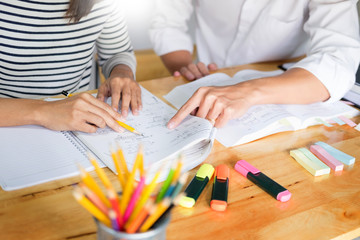 woman learn and teach tutor concept education  helping each other sitting in a table at class room.
