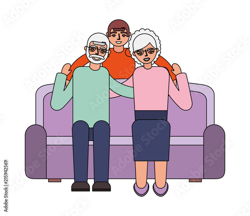 grandparents with grandson sitting on sofa