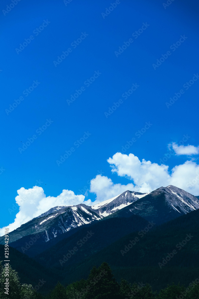 Beautiful alpine ice mountains peaks with snow, summer time, blue sky background. Beautiful alpine ice mountains peaks with snow, summer time, blue sky background.
