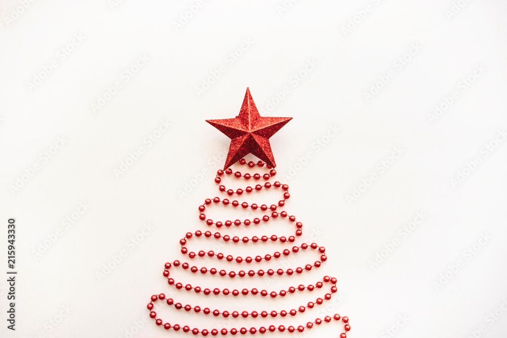Creative idea in minimalistic style for Christmas or New Year themes. Christmas fir-tree from beads and a star on top. Festive concept Creative idea in minimalistic style for Christmas or New Year themes. Christmas fir-tree from beads and a star on top. Festive concept