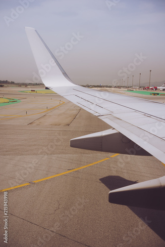 Wing of an aircraft open trailing edge flaps during landing. Airport drome photo