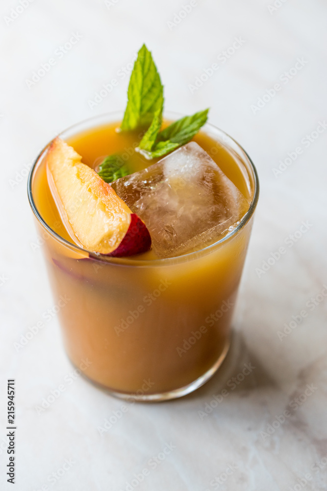 Peach Bourbon Cocktail with Peach Slice, Mint Leaves and Ice. Peach Bourbon Cocktail with Peach Slice, Mint Leaves and Ice.