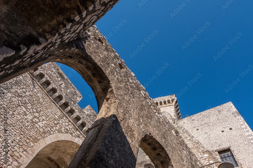 Stone castle architecture with blue sky background.