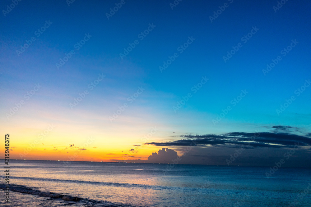 Tropical sunset on the beach of Jimbaran in Bali Indonesia