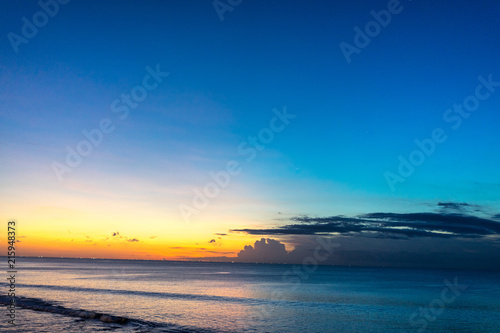 Tropical sunset on the beach of Jimbaran in Bali Indonesia © DSGNSR