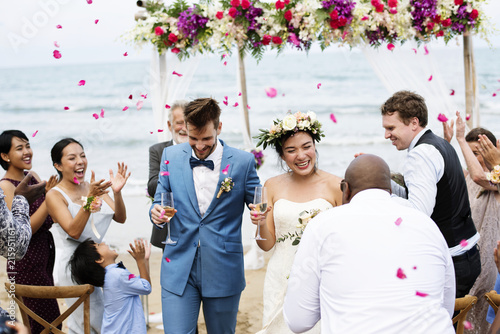 Cheerful newlyweds at beach wedding ceremnoy photo