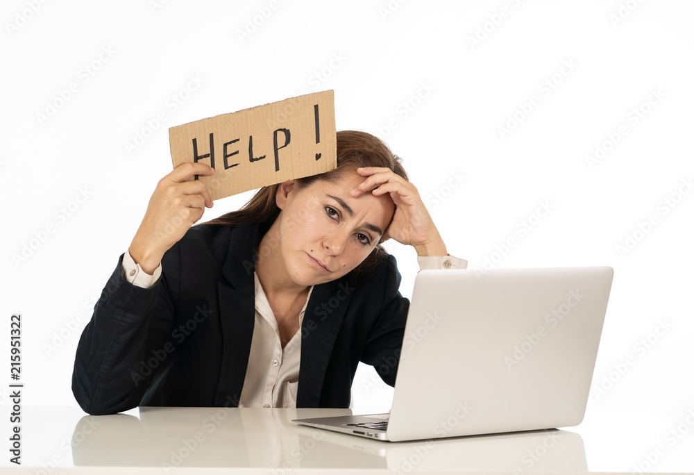 Young attractive latin woman showing help sign desperate suffering stress at work while sitting at office laptop computer desk in business overwork female feeling stressed and overwhelmed. Young attractive latin woman showing help sign desperate suffering stress at work while sitting at office laptop computer desk in business overwork female feeling stressed and overwhelmed.