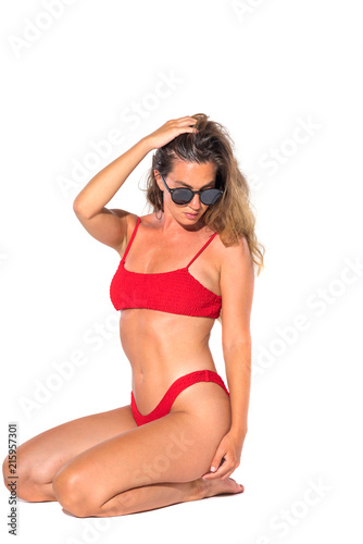 sexy young brunette woman  posing in a red bikini © Netfalls
