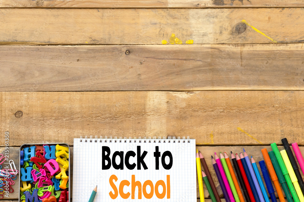 School supplies on wood background ready for your design, back to school concept