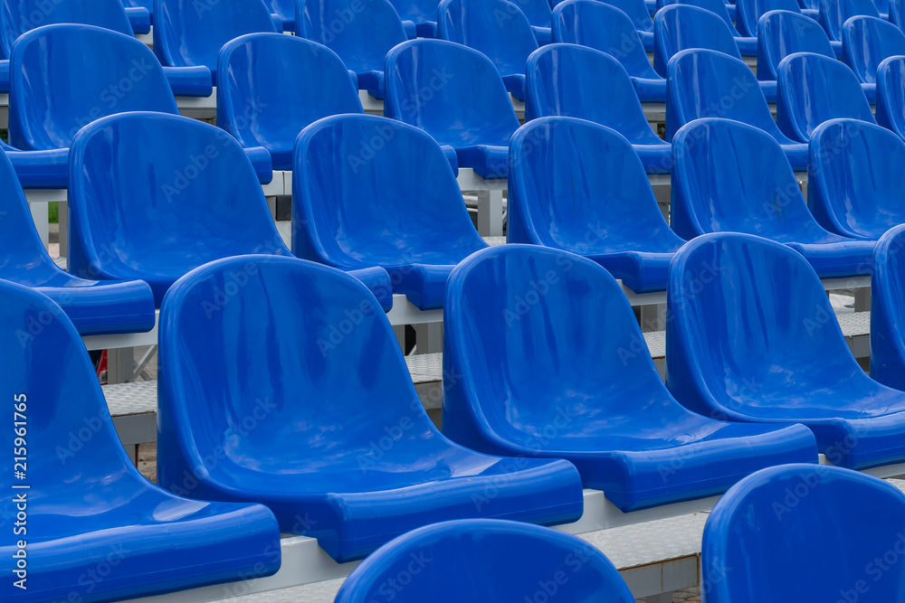 Blue empty seats in an open air amphitheater Blue empty seats in an open air amphitheater