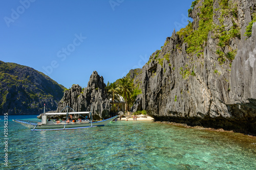 Secret lagoon with crystal clear water surrounded by rocks in El Nido Palawan. Philippine seascape with rocks. Tropical paradise in Asia