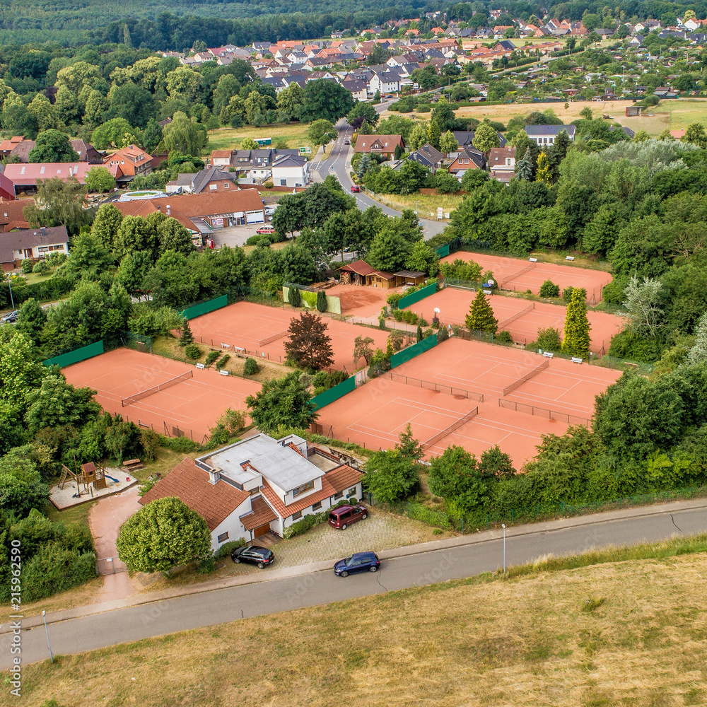 Aerial view of tennis courts and a country road on the edge of a German suburb