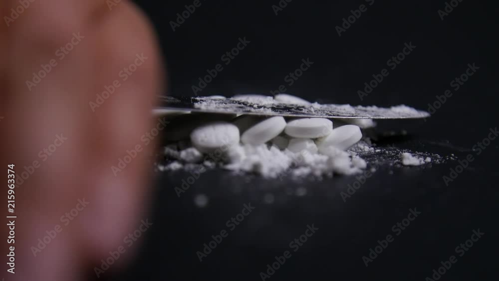 Hand Crushes Pills Into Powder in Slow Motion