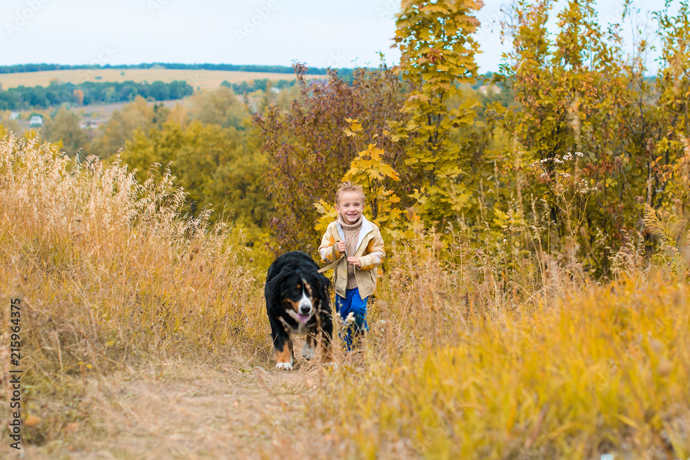 Fototapeta premium boy running around with big dog