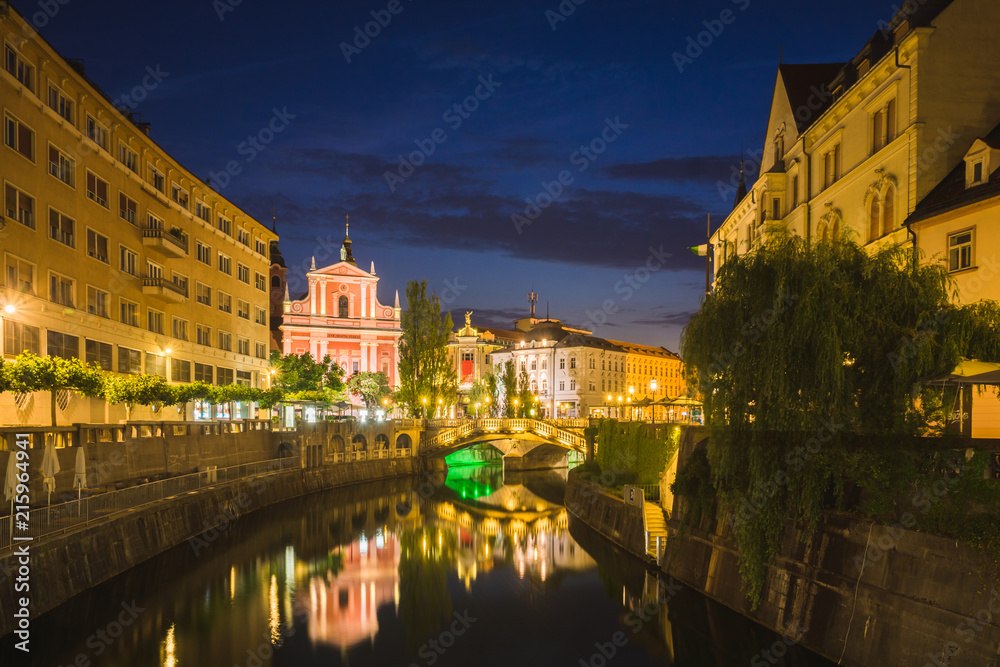 Church of the Annunciation and Lublanica river at night in Ljubljana, Slovenia