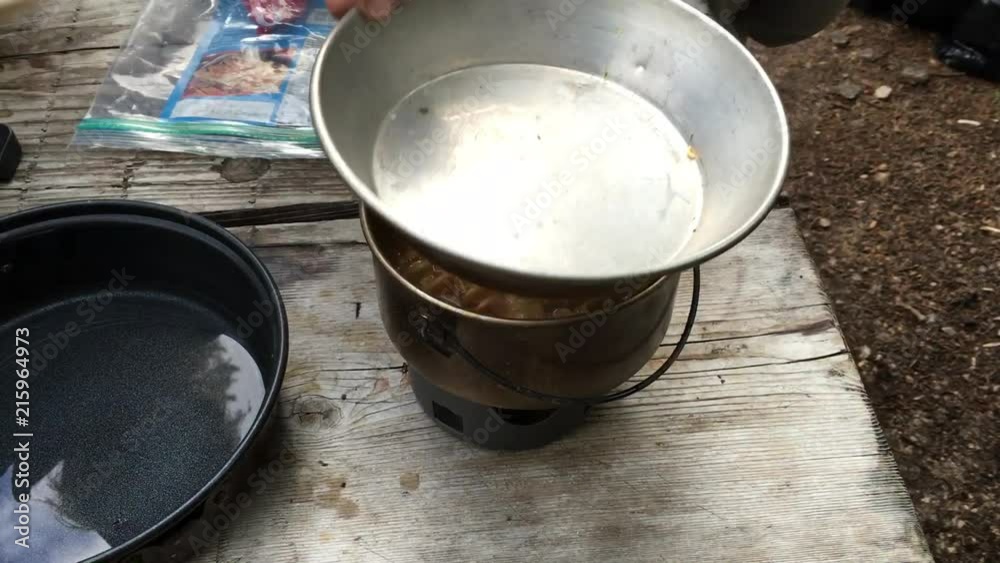 Preparing Dinner Over a Small Stove While Backpacking Preparing Dinner Over a Small Stove While Backpacking