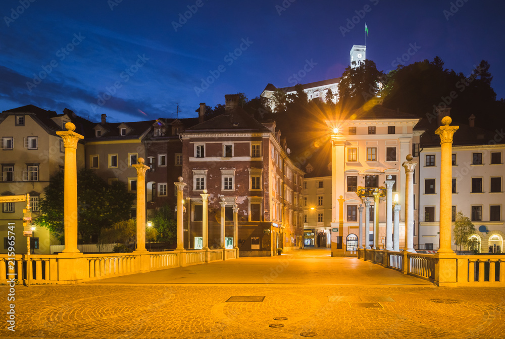 Cobblers bridge and castle at night in Ljubljana, Slovenia