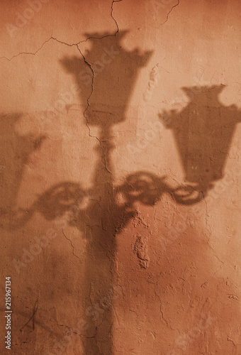 Shadow of old street lamp post on wall