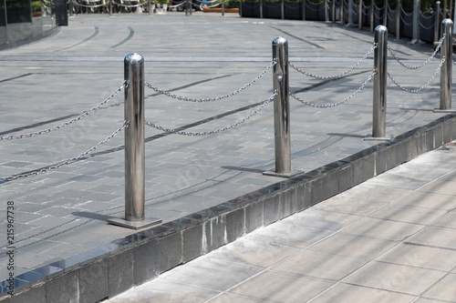 stainless steel bollards with steel chain near footpath