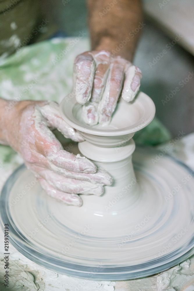 Ceramic dishes in working process. Creating ceramic pieces. Tradicional ceramic factory in spain. man working with traditional potter's wheel