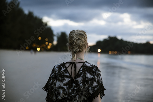 Thailand, Khao Lak, back view of woman on the beach at evening photo