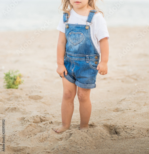 Girl is walking on the beach at sea.