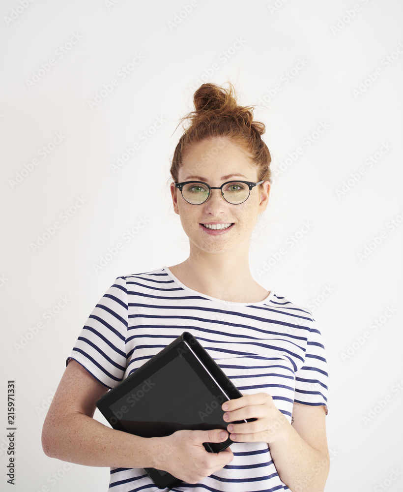 Portrait of young woman holding a tablet at studio shot Portrait of young woman holding a tablet at studio shot