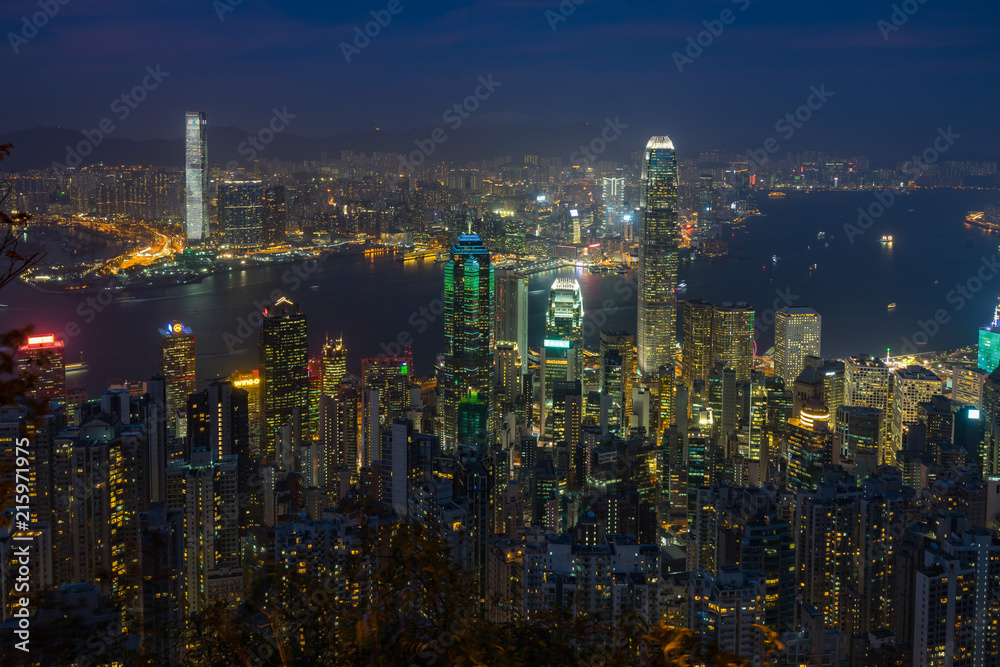 Hong Kong and Victoria Harbour cityscape at night viewed from Lugard Road near Victoria Peak