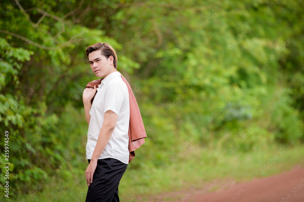 Smart young man standing on a rural street. Smart young man standing on a rural street.