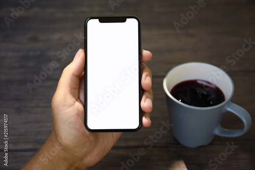 Male hands holding phone with isolated screen over the table