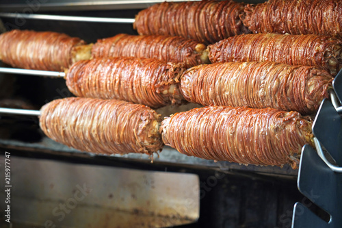 Turkish street food Kokoreç . Grilled on charcoal fire wrapped around young lamb bowel .